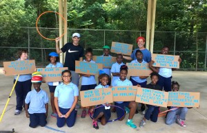 Addison Stapes and Jeﬀrey Weisberg with youth at Boulware Springs Charter School for Peace in Sports Tennis Program. 