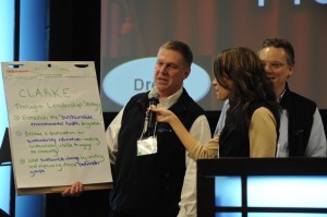 Lyell Clarke, CEO of The Clarke Group, Inc, asks his whole company to take ‘the heart of Clarke’ and its ‘project greater purpose’ to go beyond sustainability as ‘less harm’ to a net positive vision of sustainability-as flourishing.