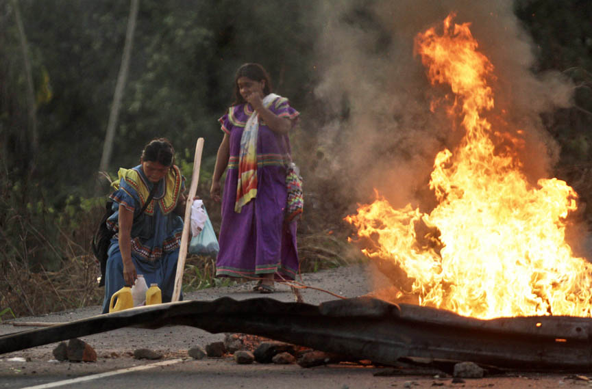 Protesters from the Ngobe-Bugle tribe block a road during a protest in El Vigui, Panama, Thursday, Feb. 2, 2012. Members of the Indian tribe blocked roads in two provinces on the border with Costa Rica in a dispute over mineral exploitation on their lands. (AP Photo/Arnulfo Franco)